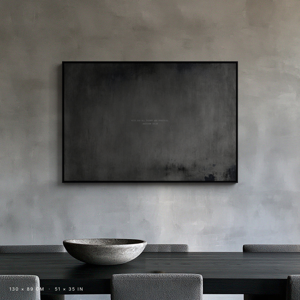 Graphite canvas, 130 × 89 cm, black floating frame, above a dining table in a New York loft