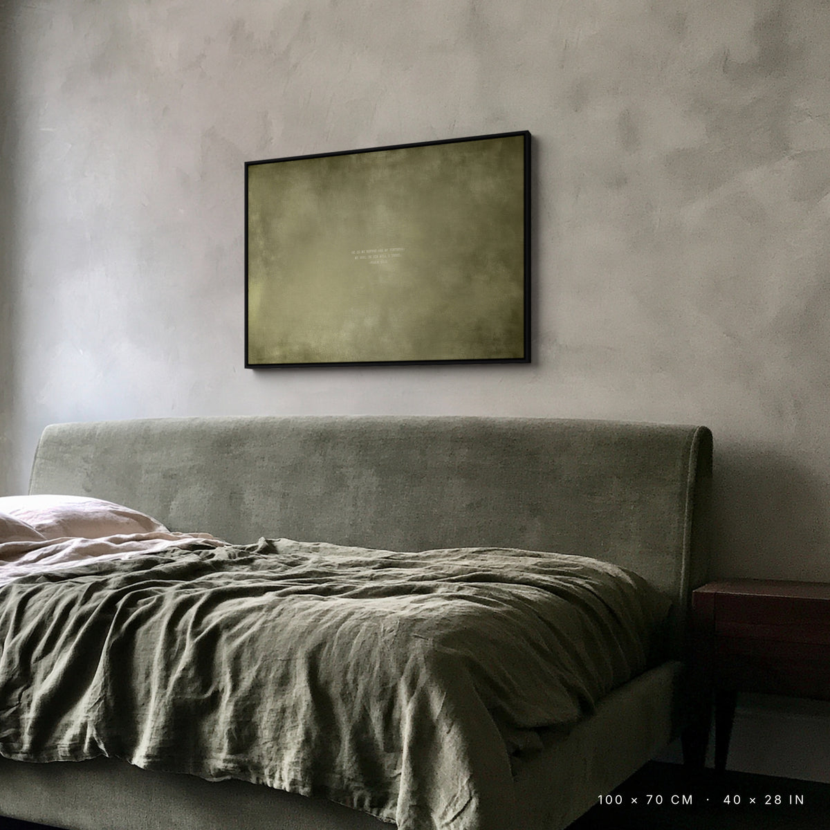 Olive canvas, 100 × 70 cm, black floating frame, above an upholstered bed in a London bedroom
